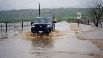 truck drives through muddy flood waters |  Michael Ho Wai Lee/ZUMAPRESS/Newscom